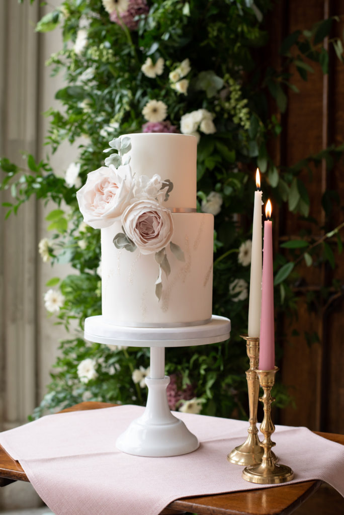 Wedding cake with tapered candles on the side