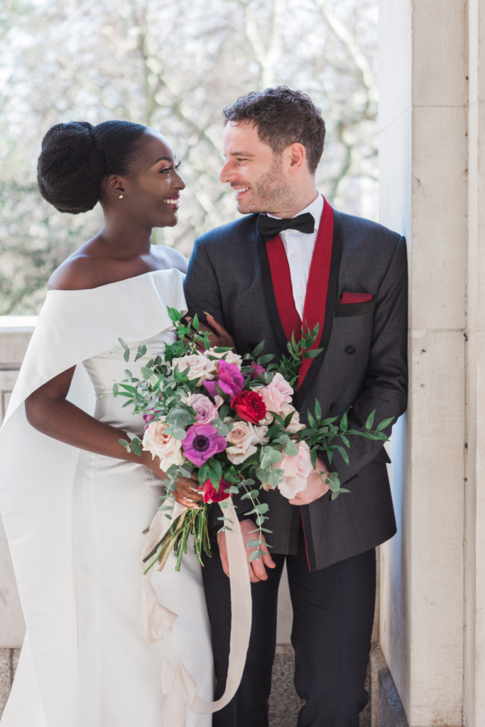 Interracial couple arm in arm at their wedding