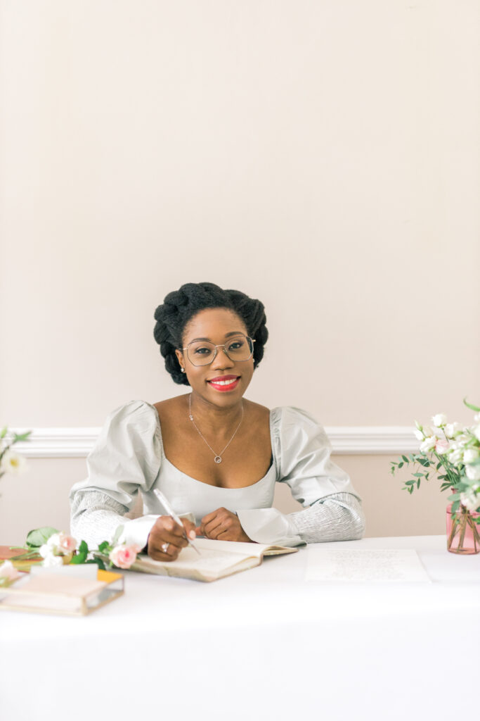 Black woman at a table writing